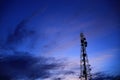 Telecommunication tower Antenna and satellite dish at sunset sky Royalty Free Stock Photo