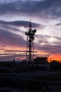 Telecommunication tower Antenna and satellite dish at sunset sky Royalty Free Stock Photo