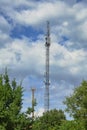 Telecommunication tower cell for mobile communications against cloudy sky. One base radio station. Royalty Free Stock Photo