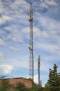 Telecommunication tower cell for mobile communications against cloudy sky. One base radio station Royalty Free Stock Photo