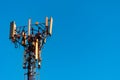 Telecommunication tower with clear blue sky background. Antenna on blue sky background. Radio and satellite pole. Communication