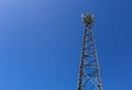 Telecommunication tower or mast with microwave, radio panel antennas, outdoor remote radio units, power cables, coaxial Royalty Free Stock Photo