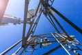 Inside view of telecommunication tower with microwave, radio antennas and cables against blue sky and sun. Inside view. Royalty Free Stock Photo