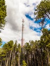 Telecommunication tower of mobile telephone network base station with smart cellular antennas radiating strong signal Royalty Free Stock Photo