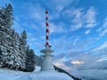 Telecommunication tower on mountain top in winter at sunset. Royalty Free Stock Photo