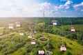 Telecommunication tower with radio antennas and satellite dishes is installed on the rural on the green field with grass Royalty Free Stock Photo