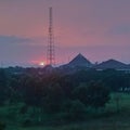 Telecommunication Tower Silhouette Against Vibrant Pink Sunset Sky at Dusk Royalty Free Stock Photo