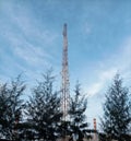 Telecommunication Tower & x28;BTS& x29; Rising Above Trees Under Blue Sky Royalty Free Stock Photo