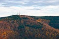 Telecommunication towers on the summit of the hill covered with colorful fall forest Royalty Free Stock Photo