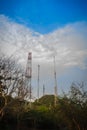 Telecommunication towers on the summit of the hill under cloudy Royalty Free Stock Photo
