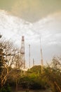 Telecommunication towers on the summit of the hill under cloudy Royalty Free Stock Photo