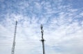 Telecommunication towers with TV antennas, network and cell phone repeaters on a sunny day with a blue sky.Telecommunication tower