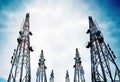 Telecommunication towers with TV antennas and satellite dish on clear blue sky Royalty Free Stock Photo