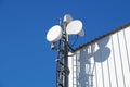 Telecommunication towers with TV antennas and satellite dish on clear blue sky Royalty Free Stock Photo