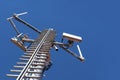 Telecommunications antenna on steel tower and blue sky in background Royalty Free Stock Photo