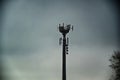 Telecommunications antennas tower silhouette under dull sky Royalty Free Stock Photo