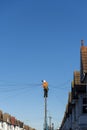 Telecommunications engineer working at the top of a telegraph pole Royalty Free Stock Photo