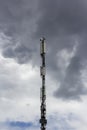 Telecommunications tower with 5G transmitters. A cellular base station with transmitting antennas.