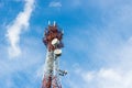 Telecommunications tower with many satellite dish on blue sky cloud background. Royalty Free Stock Photo