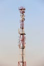 Telecommunications tower and satellite dish telecom network on blue sky with bright sun light Royalty Free Stock Photo