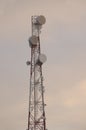 Telecommunications tower and satellite dish telecom network on evening sky Royalty Free Stock Photo