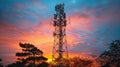 Telecommunication Tower Silhouette at Sunset with Vivid Sky and Tree Silhouettes Royalty Free Stock Photo