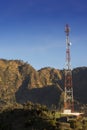 Telecommunications tower at sunrise and blue sky. Royalty Free Stock Photo