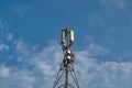 Telecommunications tower with transmitters. Base station with transmitting antennas on a telecommunications tower against the blue Royalty Free Stock Photo