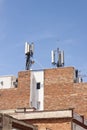 Telecommunications wireless cell phone antennas on the roof of a building. 5g high speed internet transmitters