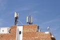 Telecommunications wireless cell phone antennas on the roof of a building. 5g high speed internet transmitters Royalty Free Stock Photo