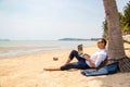 Telecommuting, businessman relaxing on the beach with laptop and palm, freelancer workplace, dream job.