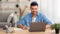 Smiling israeli man working on laptop at home Royalty Free Stock Photo