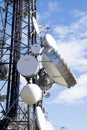 Telecomunication tower parabola in a blue sky and clouds Royalty Free Stock Photo