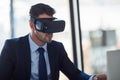 Teleconferencing just got better. a businessman wearing a VR headset while working in his office. Royalty Free Stock Photo