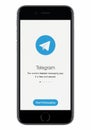 Telegram messenger launch screen with Telegram logo on black Apple iPhone 8 display