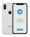 Telegram messenger launch screen with Telegram logo on Apple iPhone X display