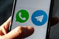 Telegram messenger vs whatsapp. iPhone with Whats app and Telegram icons. Royalty Free Stock Photo