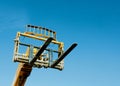 Telehandler with raised boom and forks on clear sky background