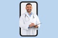 Telemedicine, appointment with doc online. Friendly middle aged doctor with clipboard at huge smartphone screen