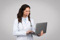 Telemedicine concept. Female doctor with laptop and headset making online consultation talking to patient via video call Royalty Free Stock Photo