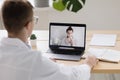 telemedicine, a young adult European and competent doctor in a white coat in a medical clinic in his office sees a Royalty Free Stock Photo