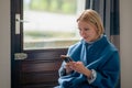 telephone communication, correspondence. A middle-aged woman in her forties is sitting with a phone Royalty Free Stock Photo