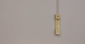 Telephone handset or receiver hanging from above on grey background