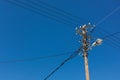 Telephone lamp pole with electrical wires against blue sky Royalty Free Stock Photo