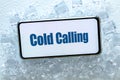 A telephone lying in the ice with the words `cold calling` Pharse, business concept of contacting and establishing cooperation Royalty Free Stock Photo