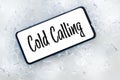 a telephone lying in the ice with the words `cold calling` Pharse, business concept of contacting and establishing cooperation