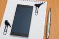 Telephone and paper clips on a notepad Royalty Free Stock Photo