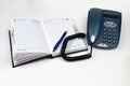 Telephone, pen and open diary Royalty Free Stock Photo