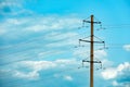 Telephone pole and wires against sky with clouds Royalty Free Stock Photo