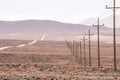 Telephone poles run through the desert in Death Valley Arizona Royalty Free Stock Photo